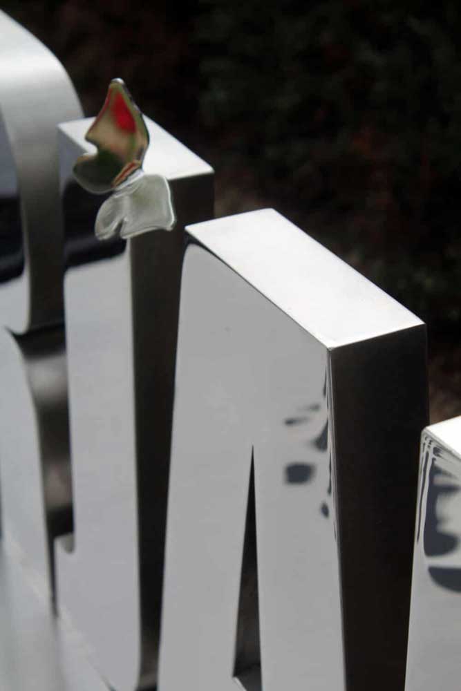 vlinder op grafmonument van rvs